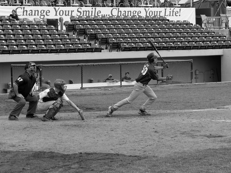 Austin batting for Cubs RBI. Background sign: “Change Your Smile... Change Your Life!”