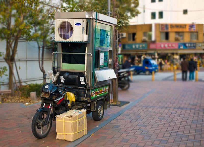 Above is a three wheeled mobile shipping office complete with Air Con...yes, there is a guy sitting in there waiting to process your shipment.