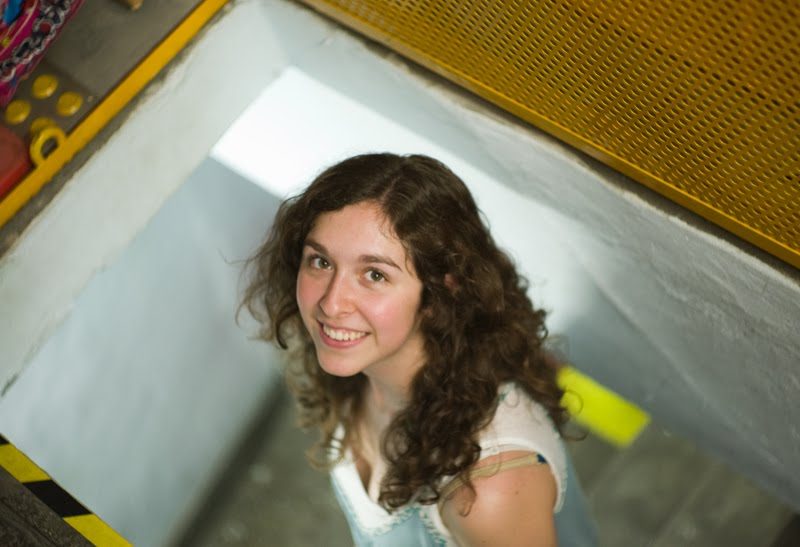 Amanda walking up the narrow stairway complete with a MotoElastico trap door...
